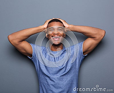 Man laughing with hands on head