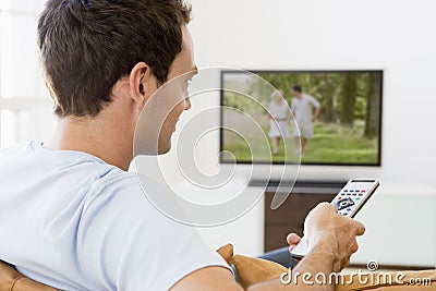 Man in living room watching television