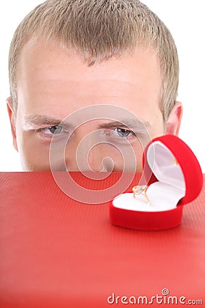 man staring at wedding ring