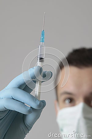 Man with medical mask and syringe