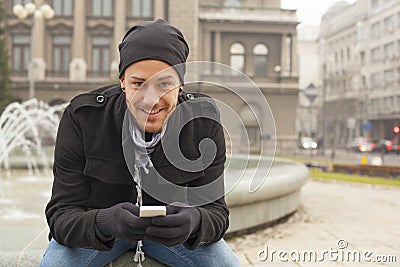 Man With Mobile Phone And Hat In City, Urban Space