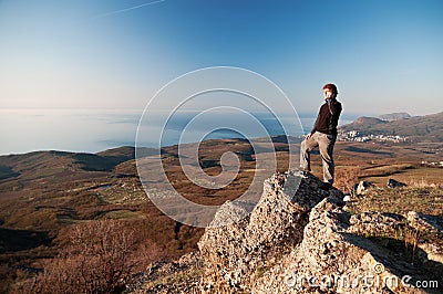 Man with mobile phone on the top of world