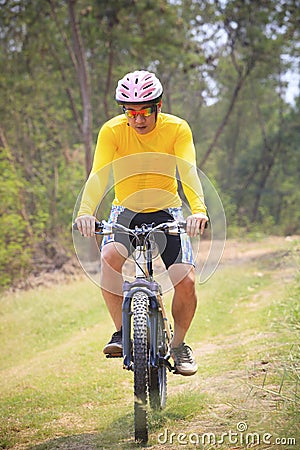 Man and mountain bike riding in jungle track use for bicycle spo