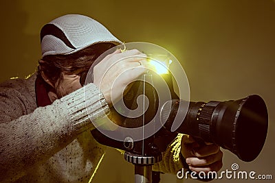 Man with old film movie camera