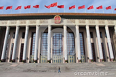 Man passing by Great Hall of People in Beijing
