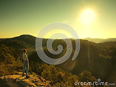 Man on the peak of sandstone rock in national park