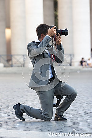 Man photographer lunges taking picture
