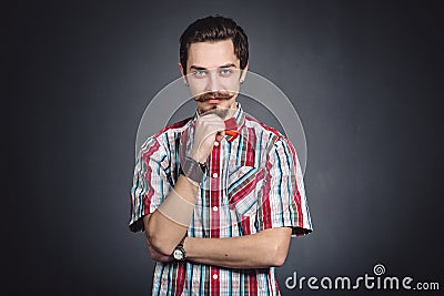 Man in plaid shirt and bow tie