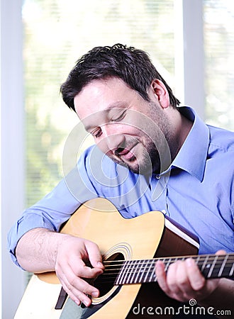 Man playing guitar indoor