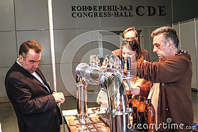 Man pouring beer to glass from beer tap