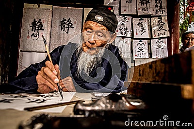 Man practising Chinese calligraphy at the Summer P