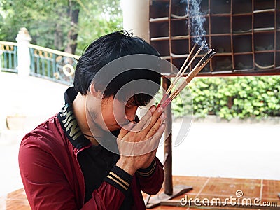 Man pray for buddha with joss stick