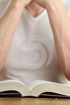 Man praying with the Bible