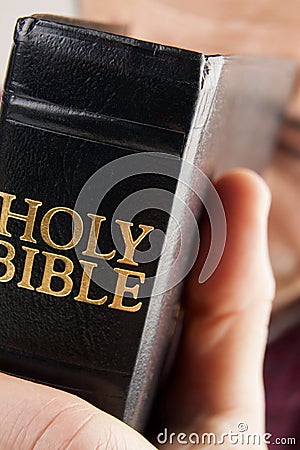 Man Praying Holding the Bible