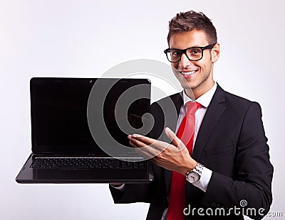 Man presenting you with a new laptop