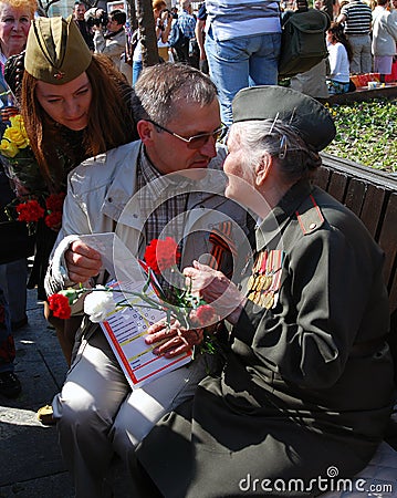 A man presents a photo to a war veteran