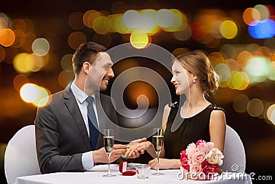 Man proposing to his girlfriend at restaurant