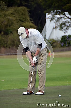 Man putting on golf greens