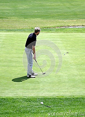 Man putting on green during game of golf