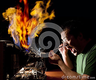 Man repairing computer on fire