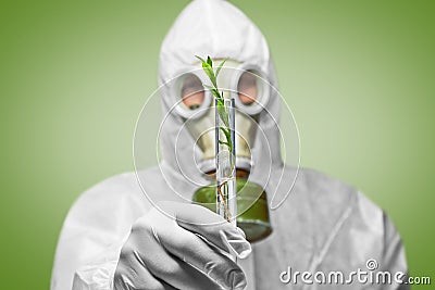 Man in respirator holds green plan