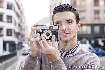 Man with retro camera in the street.