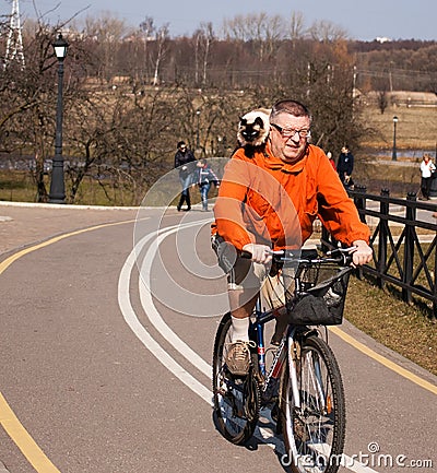 Man ride bike with cat