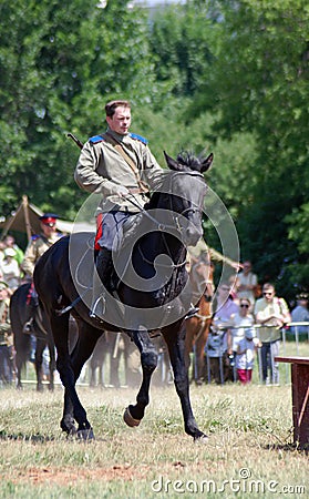 A man rides a black horse. Horse riders competition