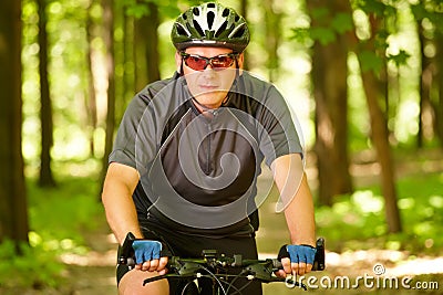 Man riding bike in forest