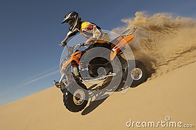 Man Riding Quad Bike In Desert