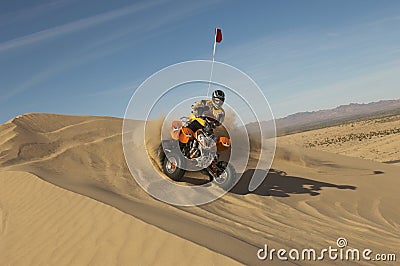 Man Riding Quad Bike In Desert