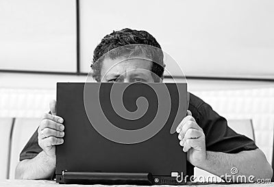 Man s eyes over laptop