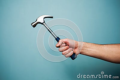 Man s hand holding hammer