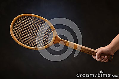 Man s Hand Holding Vintage Tennis Racket