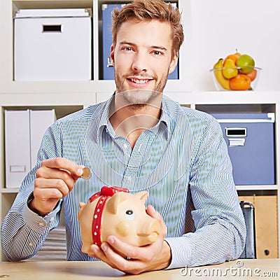 Man saving Euro money in piggy bank