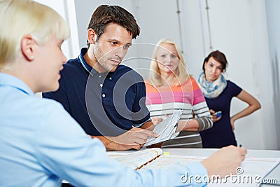 Man scheduling appointment with doctors assistant