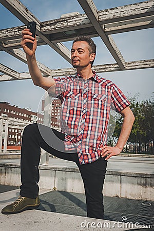 Man in short sleeve shirt taking a selfie