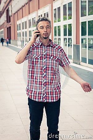 Man in short sleeve shirt talking on phone