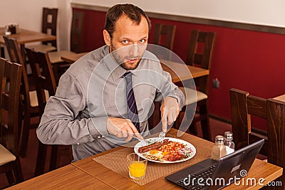 Man sitting alone in restaurant with laptop