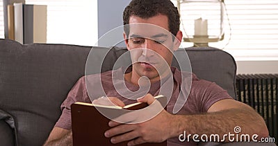 Man sitting at home writing in his journal