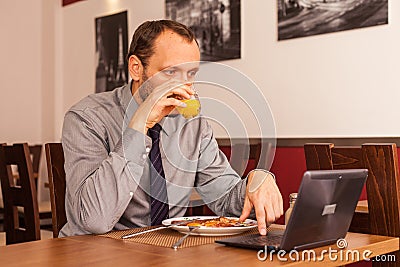 Man sitting in restaurant with laptop,and phone
