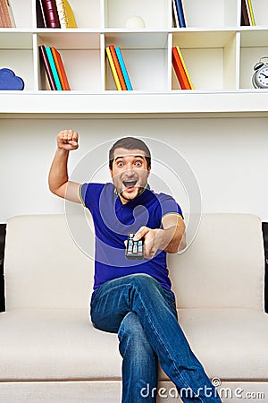 Man sitting on sofa and watching tv