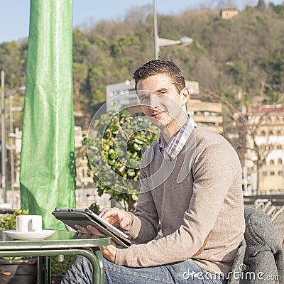 Man sitting in the terrace restaurant and laptop computer.