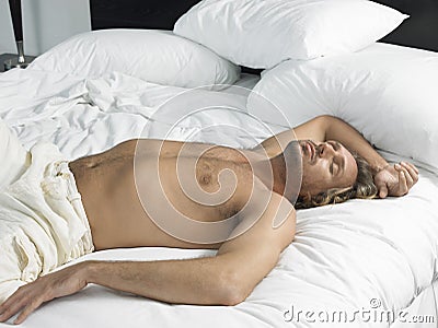 Man Sleeping In Hotel Bedroom