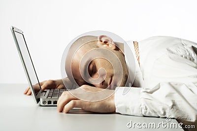 Man sleeping on laptop computer