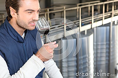 Man smelling his own wine