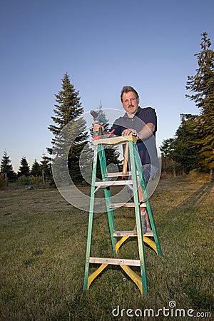 Man Smiling With Drill And Ladder