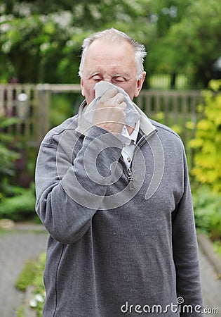 Man sneezing hay fever