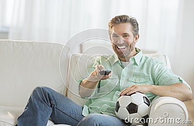 Man With Soccer Ball Watching TV