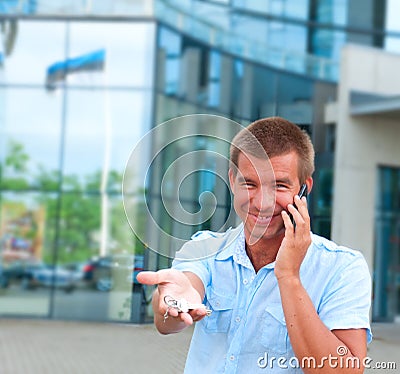 Man speaking on phone in front of modern business building